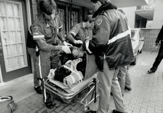 No escape from police, Ambulance attendants aid a man who plunged through a window in a McGill St
