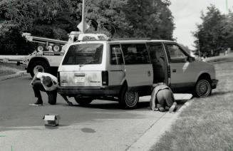 Detailed work: Members of the police identification bureau collect evidence yesterday from a van that went out of control during a police chase