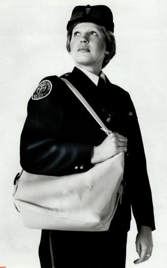Right way: Policewoman Kathy Gardiner shows safest way to carry purse close to front of body and firmly held