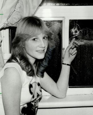 Bullet in bedroom: Thirteen-year-old Susan Hall points to the bullet hole in her bedroom window on Lansdowne Ave