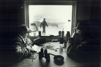 On strike: Striking miners Romeo Berube, 55, left, and Roger Warren, 49, wait in the picket line shack at Gate C, the main entrance at the Giant mine