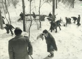 Two Detectives and 30 policemen search through snow in Muir Memorial gardens at Yonge St