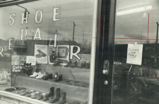 Sign on door of Matas' shoe-repair shop