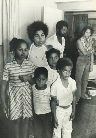 stands in her home with her children Michelle, 10 (left), Lindon, 4, Colsie, 7, and Junior Albert, 6