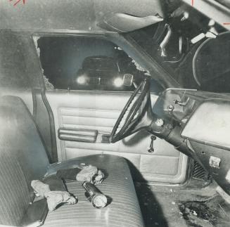 In the cruiser driven by Constable James Lothian, his gloves, flashlight and book of traffic tickets lie on the front seat after he was shot. Police d(...)