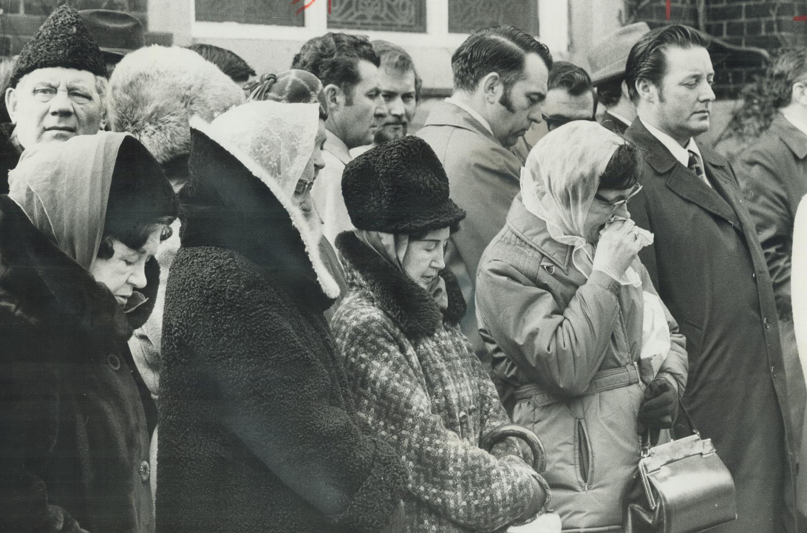 Mourners stand outside Bellefair United Church during the funeral for Constable Leslie Maitland