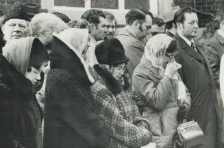 Mourners stand outside Bellefair United Church during the funeral for Constable Leslie Maitland