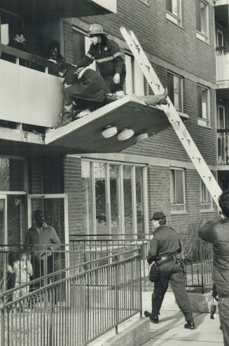 Aftermath: Fire fighters try to revive Houston on canopy over apartment entrance, but he was dead on arrival at hospital