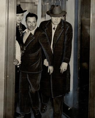 Held in slaying of George Cowboy Parker near Woodbine race rack are Peter Hylynsky, left, as material witness, and Vincent St. Lawrence, charged with murder