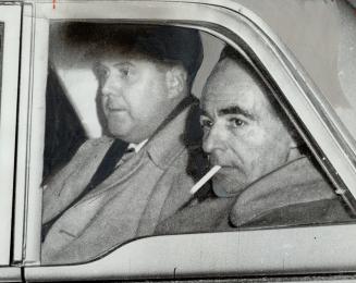Harry Wilson (right) in cruiser, He was charged with murder of man found in lane
