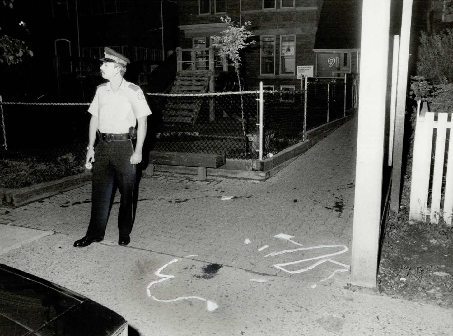 3 gunned down outside dance hall, A Metro police constable stands beside the area where a man was shot last night (chalk outline where body found) at (...)