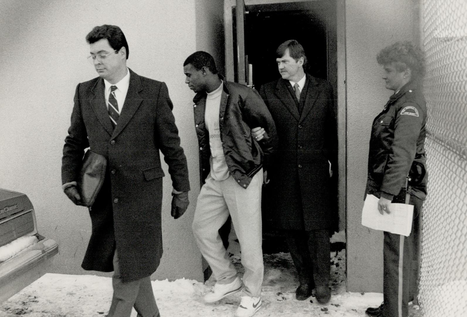 Slaying suspects: Richard Handel Smith is led from Brampton court, at right, after he and Tabrez Hamidami, above, appeared on a bail hearing