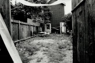 Slaying scene: Dianne George, above, was found strangled Saturday night in a tent in this backyard behind a boarding house at 60 Saulter St