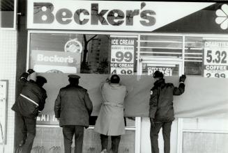 Out of sight: Metro police block the view into a Scarborough Becker's store yesterday where they are investigating the early morning slaying of a 27-year-old clerk in what appears to be a robbery