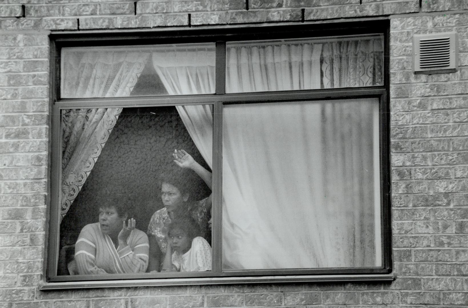 Window watching: The small window of the apartment building maintenance room where the body of a child was found is shown at top