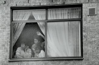 Window watching: The small window of the apartment building maintenance room where the body of a child was found is shown at top