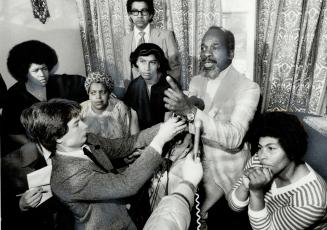 Trial criticized: Black leader Dudley Laws talks into microphones at a press conference yesterday in the home of Albert Johnson, victim of a police bullet