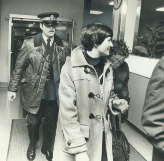 Wife of wounded Brink's messenger Evelyn Chambers, leaves Toronto East General Hospital with youngest son, Trevor (right), 13, after visiting husband,(...)