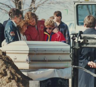 Grief revisited: Police raise the coffin of 9-year-old Christine Jessop yesterday, watched by her family (from left), father Bob, sister-in-law Debbie, brother Ken and mother Janet