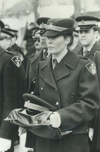 Fellow Constable Catheriene Knight carries McAleese's cap