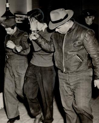 Hiding his face, William Mullen is escorted from courtroom after being arraigned on the charge of murder and remanded until Jan. 7. He was also charge(...)