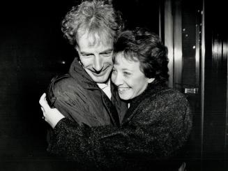 Happy hug: An ecstatic Julie Bowers wraps her arms around husband John last night after an Ontario Supreme Court jury found her not guilty in the killing of their son Dustin