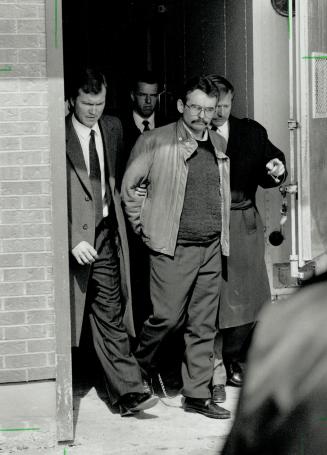Led away: Ronald York, 40, is led out of Newmarket court yesterday after getting life for the first-degree murder of York Regional officer Douglas Tribbling