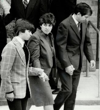 Family mourns: Marcel Babineau, 14, and his parents Jeanne and Marcel leave the church yesterday after a funeral Mass for the slain children, whose bodies were found Sunday in a schoolyard