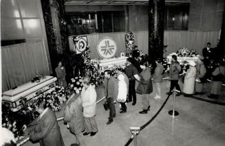 Victims mourned: Some of an estimated 8,000 visitors file past the coffins of eight of the women murdered at the University of Montreal