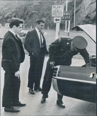 Checkpoints slow separatist boss, Quebec separatist leader Pierre Bourgault (left) stands by while police search his car for explosives and weapons while he was travelling to Quebec City for rally