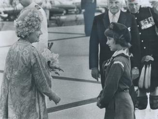 Queen Mother received a bouquet from girl Guide Frances Leamrent, daughter of Col