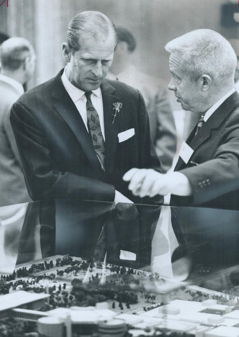 Prince Philip visited the newly opened Ontario Science Centre yesterday and was shown around by the director-general, Dougles Omand (right). Scores of(...)