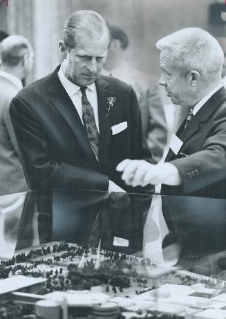 Prince Philip visited the newly opened Ontario Science Centre yesterday and was shown around by the director-general, Dougles Omand (right). Scores of(...)