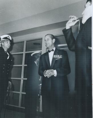 Prince Philip receives the traditional honor of being piped aboard HMCS York, even though it is a landbound naval headquarters, before signing the gue(...)
