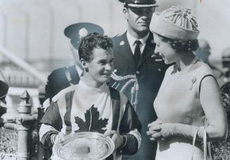 Royal congratulations: Queen Elizabeth chats with jockey Ron Turcotte in the winner's circle after he rode Fanfreliche to victory in the Manitoba Centennial Derby yesterday