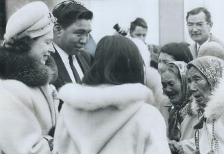 Queen Elizabeth chats with Eskimo women in the left photo during her visit to Frobisher Bay's Eskimo museum yesterday