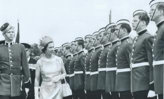 An Honor Guard of Royal Military College cadets lines up in the Kingston railway station for inspection by the Queen, who is escorted by the guard com(...)