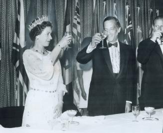 Kingston Mayor George Speal lifts his glass in a toast to the Queen at a civic dinner last night in a hall at Kingston University. The meal included d(...)
