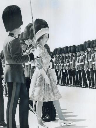 The Queen reviews an honor guard of the Royal Canadian Regiment at the airport