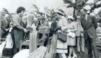 In High Park, the Queen learns how brooms were made in the 19th century in a demonstration of crafts arranged by representatives of Black Creek Pionee(...)