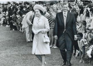 Premier William Davis walks with the Queen today during ceremonies at Queen's Park