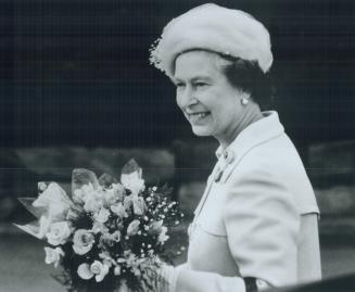 Regal smile: Queen Elizabeth smiles as crowds cheer her at Windsor's Dieppe Park, named in horo of essex Scottish Regiment Soldiers killed in the 1942 Dieppe raid
