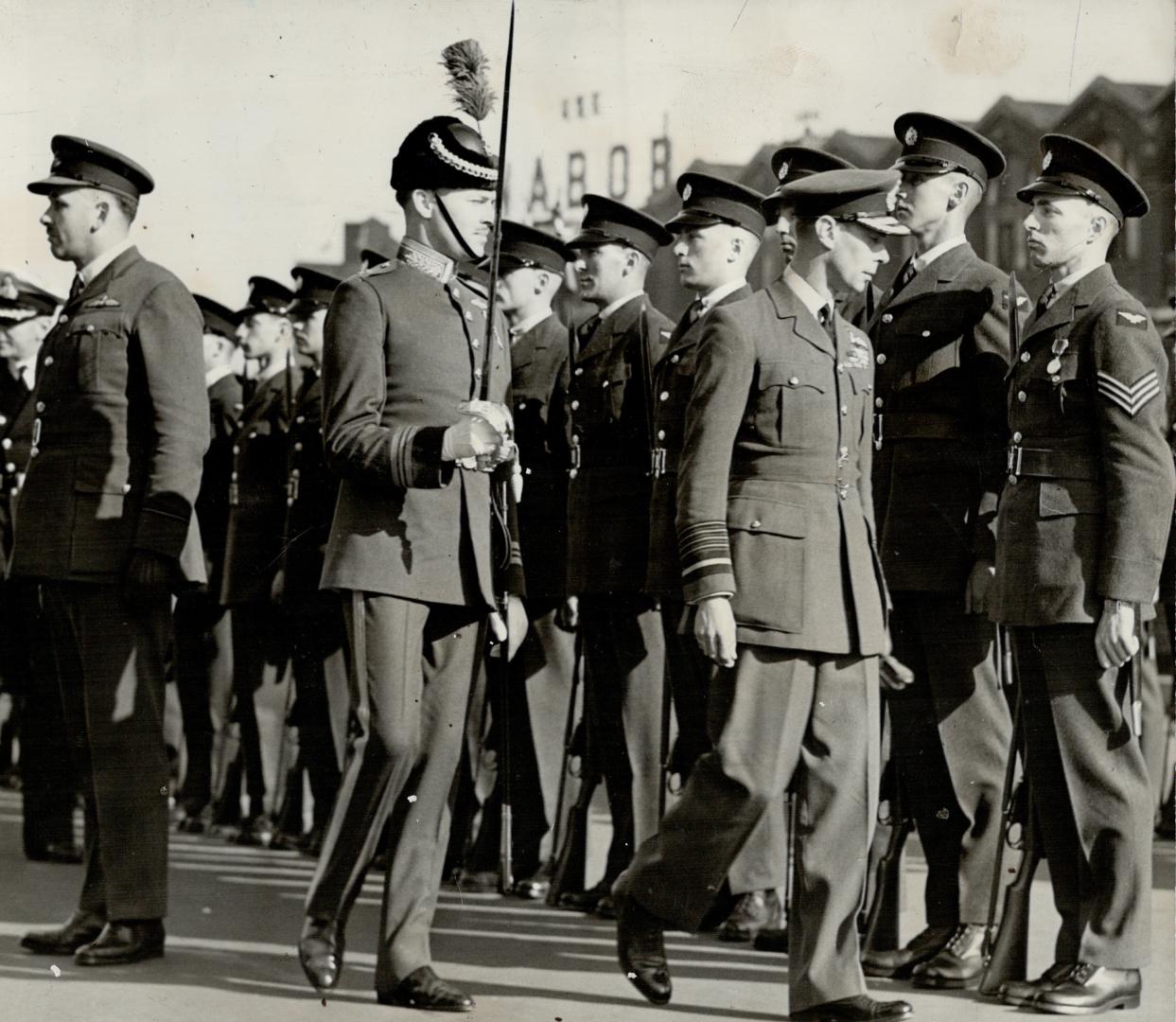 The King, wearing for the first time since the royal tour started, the undress uniform of a Royal Air Force Marshal, inspects a detachment of the Royal Canadian Air Force stationed at Vancouver