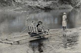 Hatless in tropic sun, Princess Margaret Floats down Jamaican river on Bamboo Raft