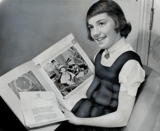 Kathy Wismer, 10, with royal tour scrapbook