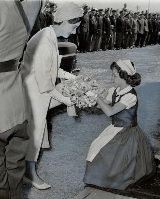 At Annapolis, N.S., the Princess received flowers from a little girl. She left the train in the station there to mingle with the crowds on the platform