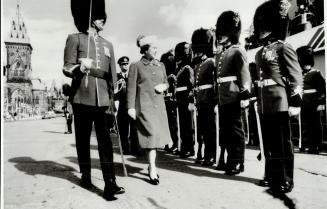 Arriving in Ottawa, the Queen inspects Royal 22d Regiment honor guard