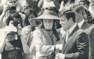 Shell shock: Sarah far left, at Ontario Games for the Physically Disabled at North York Stadium, is taken aback after firing her starter pistol and, above, dons ear protectors when Andrew fires his