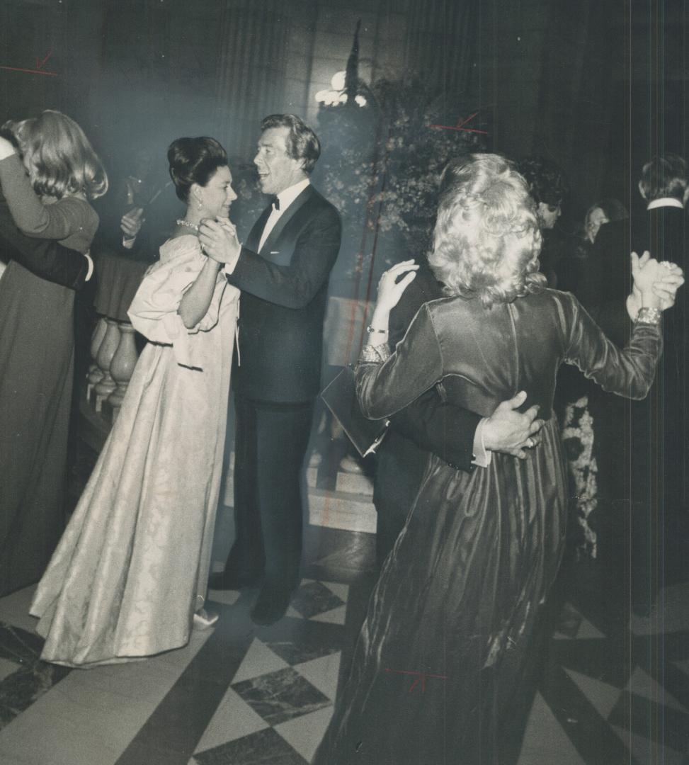Princess Margaret, in brocaded Elizabethan-type of gown, dances with her husband, Lord Snowdown, at state ball in legislative building in Winnipeg on (...)