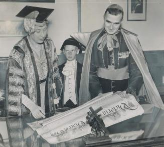 The Princess Royal visited Laval university at Quebec yesterday on her tour of Canada and here she examines the university charter which was granted by Queen Victoria